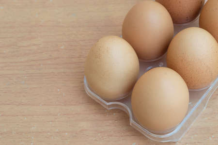 Chicken egg in panel eggs on wood backgroundの写真素材