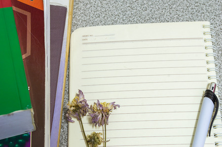 Flower pen book and a notebook on a desk