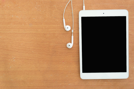 Headphones and tablet on the table の写真素材