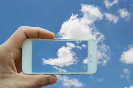Modern smartphone with sky backgroundの写真素材