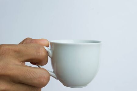 hand with white cup isolated backgroundの写真素材