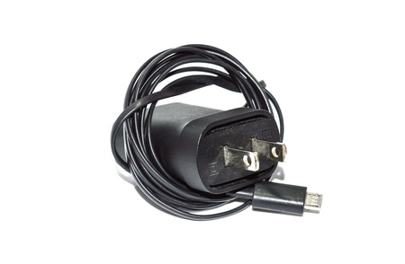 Old phone charger isolated on white background