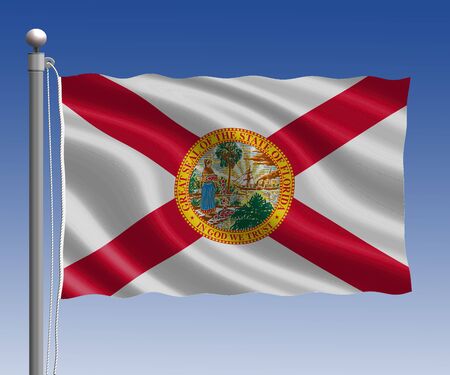 Florida flag in pole on blue sky backgroundの写真素材