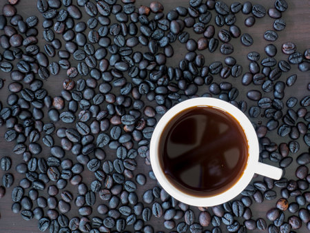 Hot coffee in cup and around with coffee beans.の写真素材