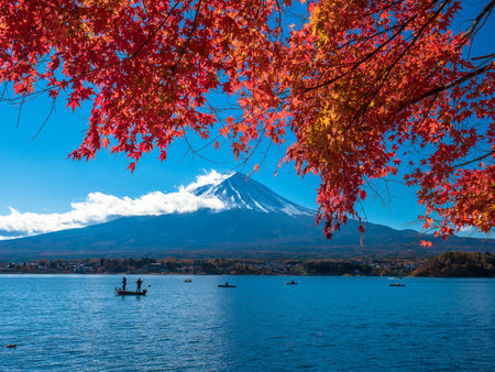 Fuji mountain with red maple and lake in foreground.