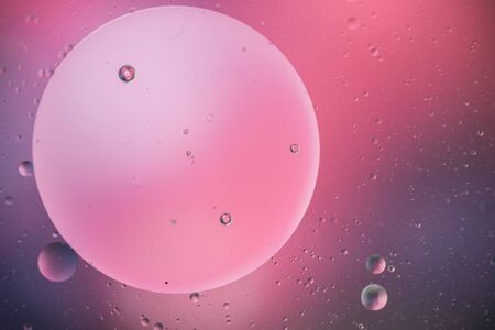 macro of oil mixed with water on colorful gradient background