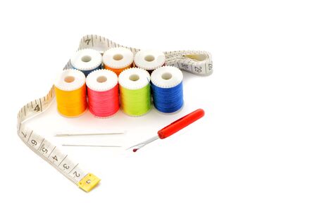 Multi-colored thread,Scissors, sewing needle, tape measure,thread picker clothing repair concept.の写真素材