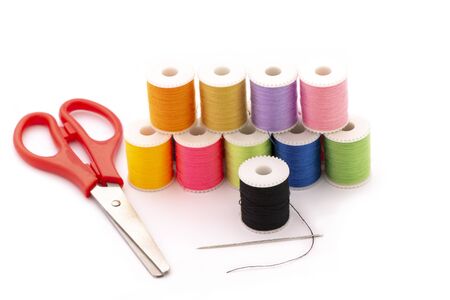 Multi-colored thread,Scissors, sewing needle, tape measure,thread picker clothing repair concept.の写真素材