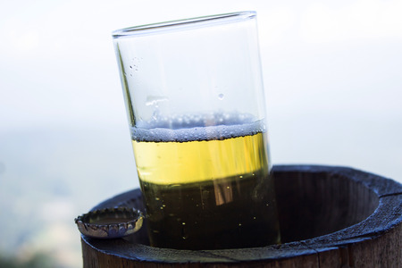  glass of beer with drops on the mountainの写真素材