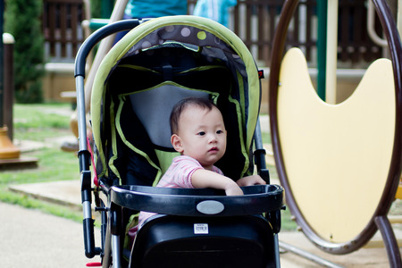 Baby girl resting happily in the parkの写真素材