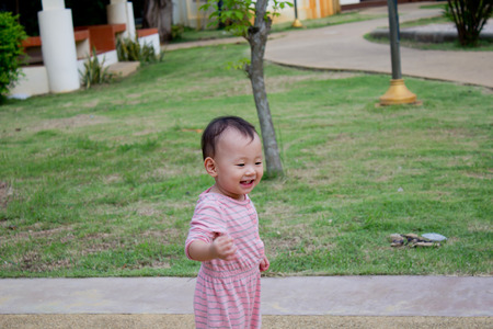 Baby girl resting happily in the parkの写真素材