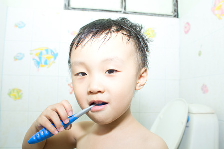 Asian boy in a showerの写真素材