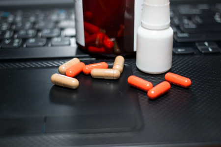 many pills and computer keyboardの写真素材