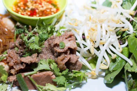 A bowl of dry noodles on wood tableの写真素材