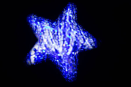 Defocused star bokeh on christmas lightの写真素材