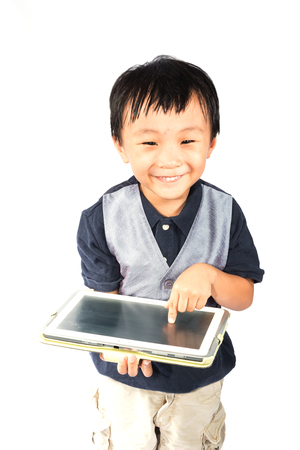 asian boy using computer tablet isolate on whiteの写真素材