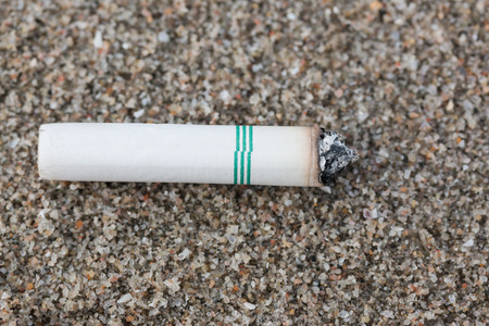 Cigarette butts in the sand on beach