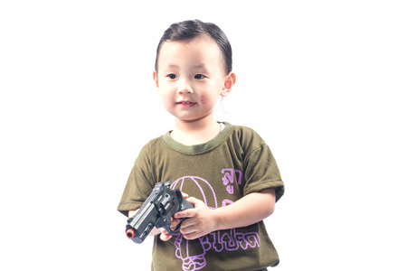little girl with gun isolated on white backgroundの写真素材