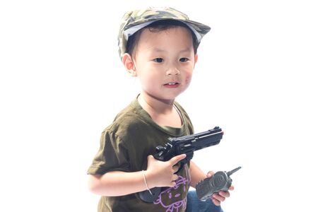 little girl with gun isolated on white backgroundの写真素材