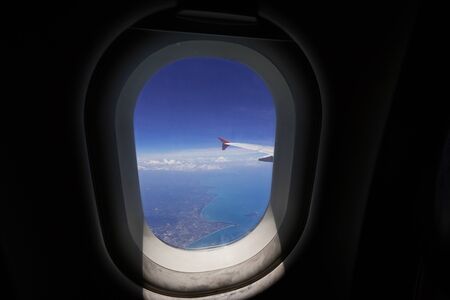 Looking through window aircraft during flight in wing with top viewの写真素材