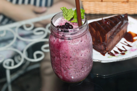 Organic Blueberry Smoothy made with fresh ingredients with chocolate cakesの写真素材