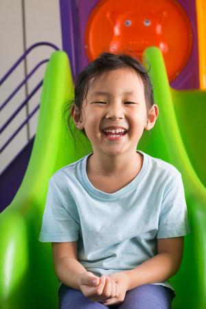 Lovely asian girl are playing in the playgroundの写真素材