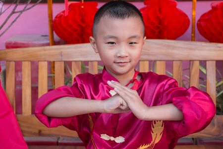 Asian boy  in red Chinese dress during Chinese New Year Celebrationの写真素材