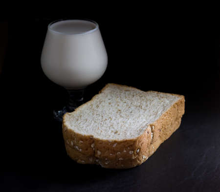 Bread with milk isolate on Black backgroundの写真素材
