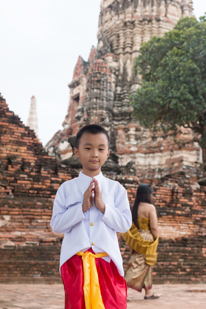 Asian boy wearing thai dress in ancient templeの写真素材