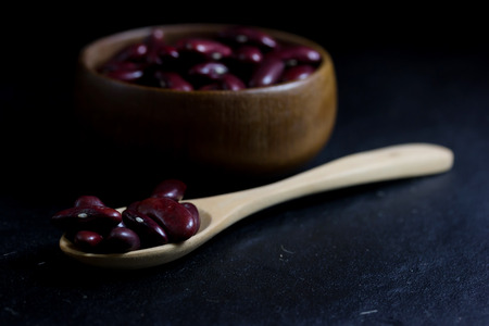Red Peanut on Cup made of wood and spoonの写真素材