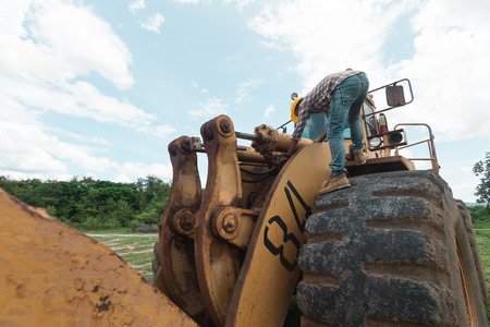 Repairman is repairing tractor in the mines in power plantの写真素材
