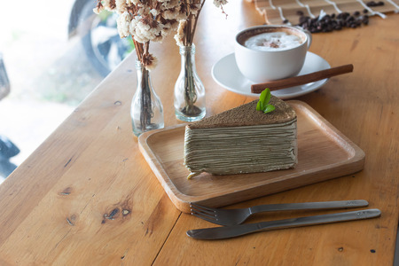 Cake and hot coffee in cup on the wooden tableの写真素材