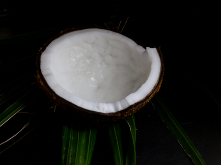 Coconut half isolate on black background