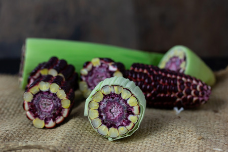 Fresh Purple corn On the black wood table