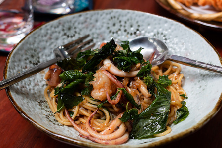Sea food Spaghetti Put fresh shrimp and green Basil Leavesの写真素材