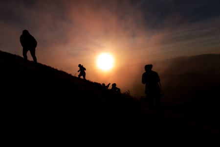 tourist Climbing at the top of the mountain During sunsetの写真素材