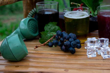 grape wine and draft beer in glass on Chair made of bambooの写真素材