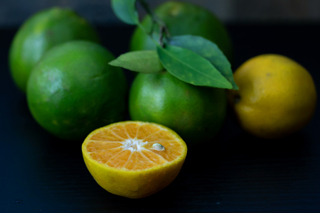 Fresh orange from the garden Cut half On the black wood tableの写真素材