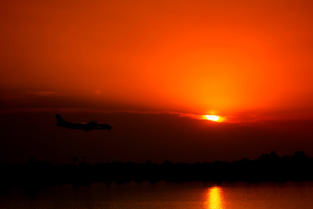 The plane is about to land In the evening and Sunset