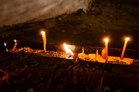 Candle lit tradition, walk with lighted candles in hand around a temple with beautiful moonの写真素材