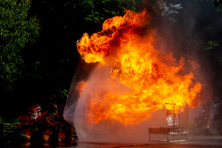 Firefighters are practicing firefighting plans are putting out a burning fireの写真素材