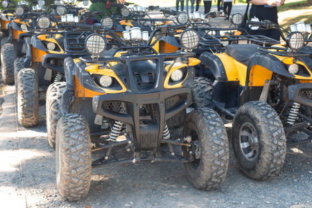 Group of four wheeled ATV cars parked in the park.