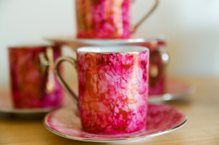 Tea cups and saucers in pink colorの写真素材