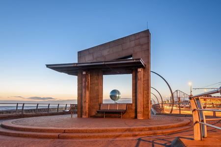 View of a mirror ball through a seating shelter on the South shore of Blackpool promenade, UK