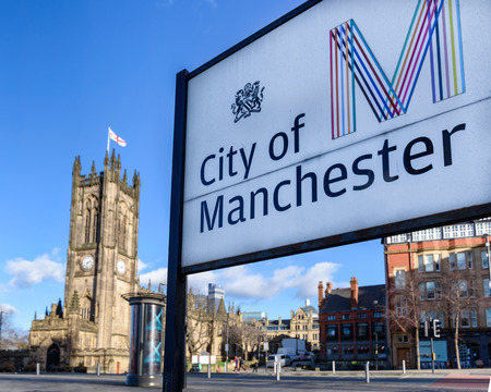 Sign board of Manchester city with Collegiate church in its background.のeditorial素材