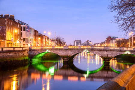 Famous 'Ha'penny Bridge' in Dublin over colorful Liffey river at nightのeditorial素材