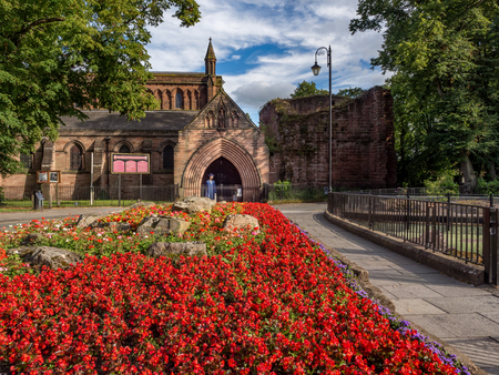 City of Chester, England. Picturesque spring view of a flower bed with St Johnの写真素材