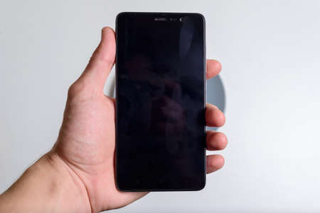cell phone in male hand isolated over white