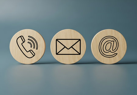 Three wooden circles with contact icons phone mail at symbol communication telephoneの素材