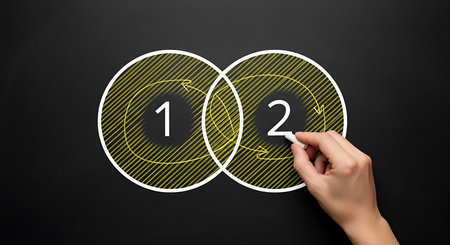 Hand drawing Venn diagram with numbers 1 and 2 on blackboard chalkの素材